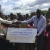 County Business Manager - Baringo County, Stephen Mwenesi, presents a dummy Cheque of Shs.943,325/- to Headteacher Donald Tanui, of Kenet ECDE & Pri Sch, in Mogotio, Baringo County